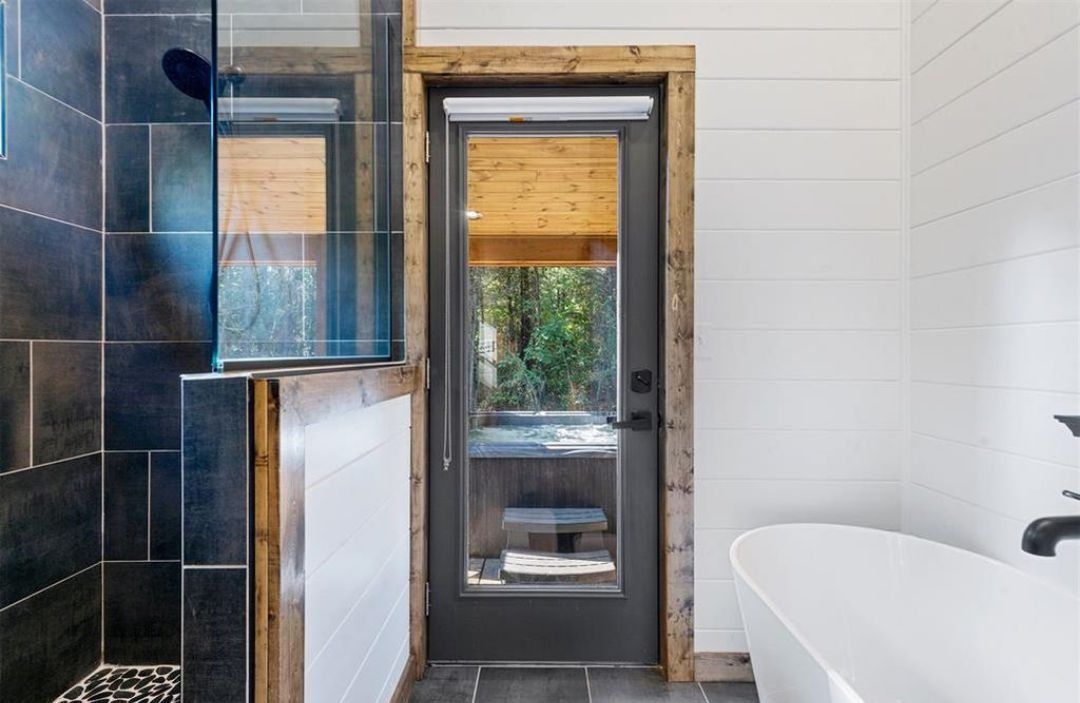 Soaking tub and walk-in shower in the Cedar & Steam cabin bathroom